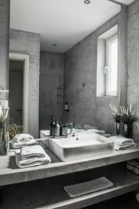 a bathroom with a large sink and a mirror at Superior One Luxury Apartments in Thessaloniki