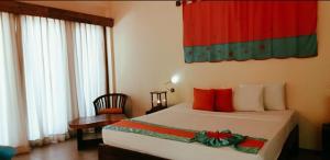 Voodi või voodid majutusasutuse Giman Free Beach Resort toas