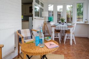 a kitchen and dining room with a table and chairs at The Lodge, Aldringham in Aldringham