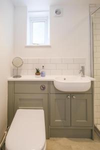 a bathroom with a sink and a toilet at The Lodge, Aldringham in Aldringham