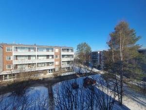 an aerial view of a building and a river at Kaksio keskustan vieressä in Rovaniemi +9 photos