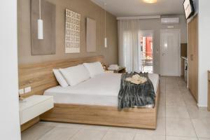 a bedroom with a large white bed in a room at Medusa studios in Sarti