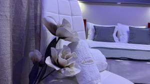 a bedroom with a bed and a bouquet of flowers at PREMIUM SUITES in Ofrínion
