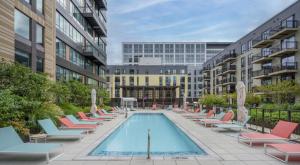 a pool in a courtyard with lounge chairs at Somerville 1br w gym wd nr Assembly T BOS-784 in Somerville