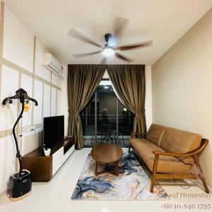a living room with a couch and a ceiling fan at GELANG PATAH Forest City-Ataraxia Park 3 in Gelang Patah