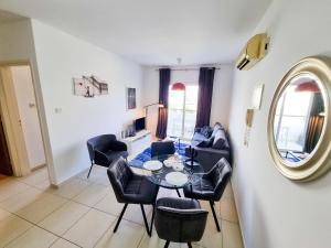 a living room with a table and chairs at Seaside Heaven Apartment With Pool in Larnaca