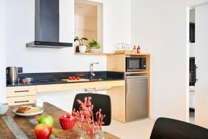 a kitchen with a table with apples on it at Eco Boutique Hostal Grau in Barcelona