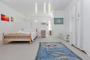 a bedroom with a bed and a rug at Kite Beach House Langebaan in Langebaan