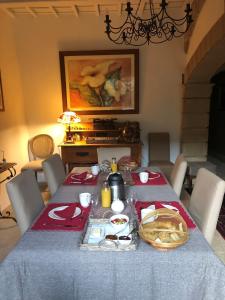 a dining room table with a blue table cloth at L'ORANGERIE Chambres d'hotes de charme in Valros