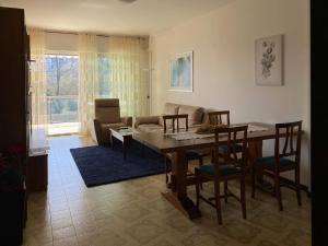 a living room with a table and chairs and a couch at Marconi Lake View in Baveno