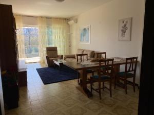 a living room with a table and chairs and a couch at Marconi Lake View in Baveno +11 photos