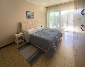 a bedroom with a large bed and a window at Marconi Lake View in Baveno