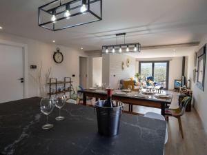 a dining room and living room with wine glasses on a table at Casa Rural El Moradel Añon in Añón