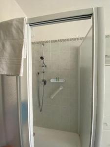 a shower with a glass door in a bathroom at Marconi Lake View in Baveno