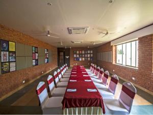 a long dining room with a long table and chairs at Kripanidhi Retreat Rajgir in Rājgīr