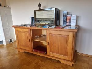 a wooden cabinet with a microwave on top of it at Ferienwohnung Toni in Freyung