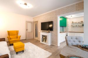 a living room with a fireplace and a tv at Doctors Garden - Central&Modern 2BD Flat in Sofia in Sofia