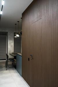 a room with a wooden partition with a table and a tableasteryasteryasteryastery at NL group apartments in Kolomiya