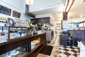 a bakery with a checkered floor and a counter at Cafe & Guest House Nagonoya in Nagoya