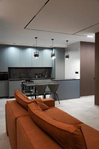a kitchen with a couch in the middle of a room at NL group apartments in Kolomiya
