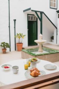 a table with plates of food and drinks on it at Studio Canario with patio - Casa del Indiano in La Orotava