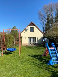 a yard with playground equipment in front of a house at Nordwind Sjut in Warnow