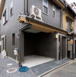a building with a garage with a fan on top of it at Kotori house - Vacation STAY 05673v in Kyoto
