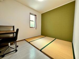 a room with a bed with a chair and a window at Kotori house - Vacation STAY 05673v in Kyoto