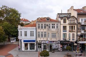 a group of buildings on a city street at Top location in center and paid parking in Varna City