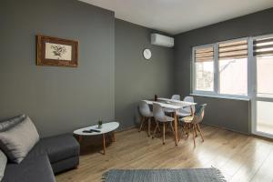 a living room with a couch and a table and chairs at Top location in center and paid parking in Varna City