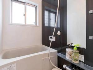 a bathroom with a bath tub and a window at Kotori house - Vacation STAY 05673v in Kyoto