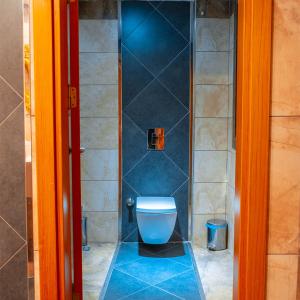 a bathroom with a toilet with a glass shower at Mevre Hotel in Antalya