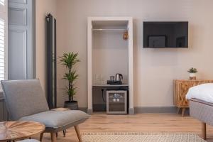 a living room with a bed and a tv at The Arran, St Andrews in St. Andrews