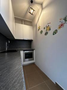 a kitchen with white cabinets and a stove at EVa's Luxury Apartments No 1 in Áyios Spirídhon