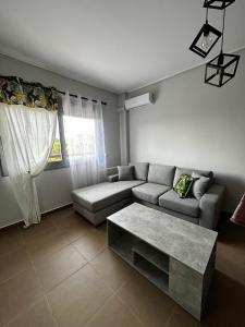 a living room with a couch and a table at EVa's Luxury Apartments No 1 in Áyios Spirídhon