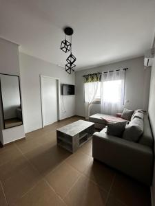 a living room with a couch and a table at EVa's Luxury Apartments No 1 in Áyios Spirídhon