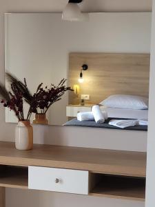 蒂锡利维ROULA STUDIOS的卧室里有一张带木质床头板的大床