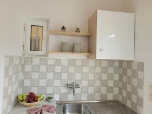 a kitchen with a sink and a bowl of fruit at ROULA STUDIOS in Tsilivi