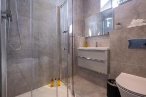 a bathroom with a shower and a toilet at The Arran, St Andrews in St. Andrews