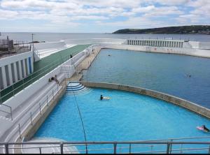 a swimming pool on a cruise ship with people in it at Market House, Mousehole in Mousehole