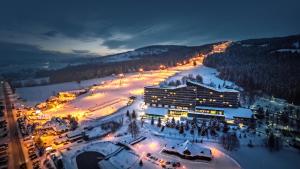 a ski resort in the snow at night at Bachleda Hotel Kasprowy in Zakopane
