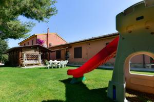 a slide in the yard of a house at Agriturismo Brancalino in Magliano in Toscana +13 photos
