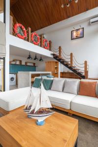 a living room with a sail boat on a table at Villa Captain no 3 in Dalung