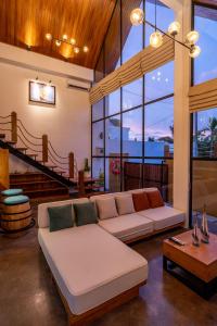 a living room with a couch and a table at Villa Captain no 3 in Dalung