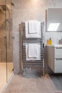 a bathroom with a towel rack with towels at The Arran, St Andrews in St. Andrews