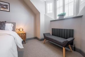 a bedroom with a bed and a chair at The Arran, St Andrews in St. Andrews