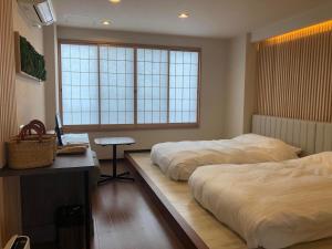 Ένα ή περισσότερα κρεβάτια σε δωμάτιο στο Yumura Onsen MIDORIYA