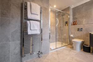 a bathroom with a shower and a toilet at The Arran, St Andrews in St. Andrews