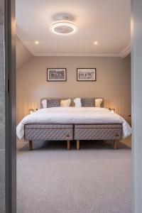 a bedroom with a large bed in a room at The Arran, St Andrews in St. Andrews