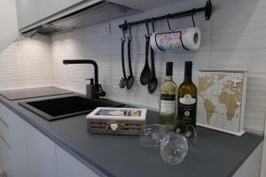 a kitchen with two bottles of wine on a counter at Regina's home in Bari